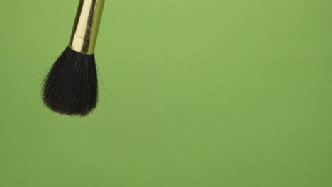 movement of the makeup brush to the sides on a green background