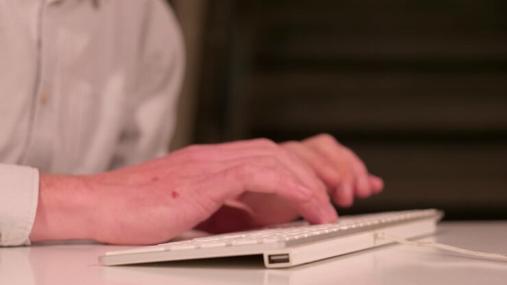 Closeup of man's hands calculates and types on keyboard, focus work, static