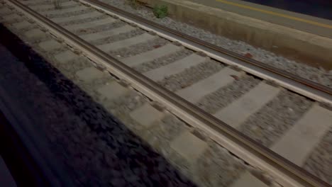 fast moving railway tracks shot from train pulling out of station