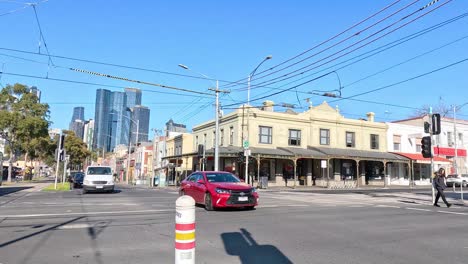 tram and car crossing busy melbourne intersection