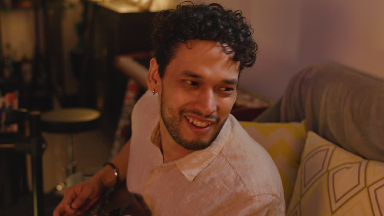 Man playing guitar on a couch