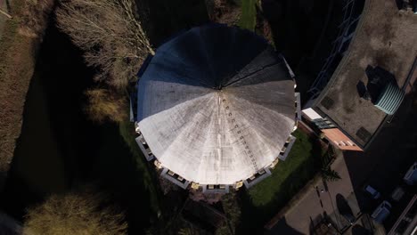 Top-down-aerial-view-of-dome-and-reveal-of-former-Dutch-brick-water-tower-in-Zutphen