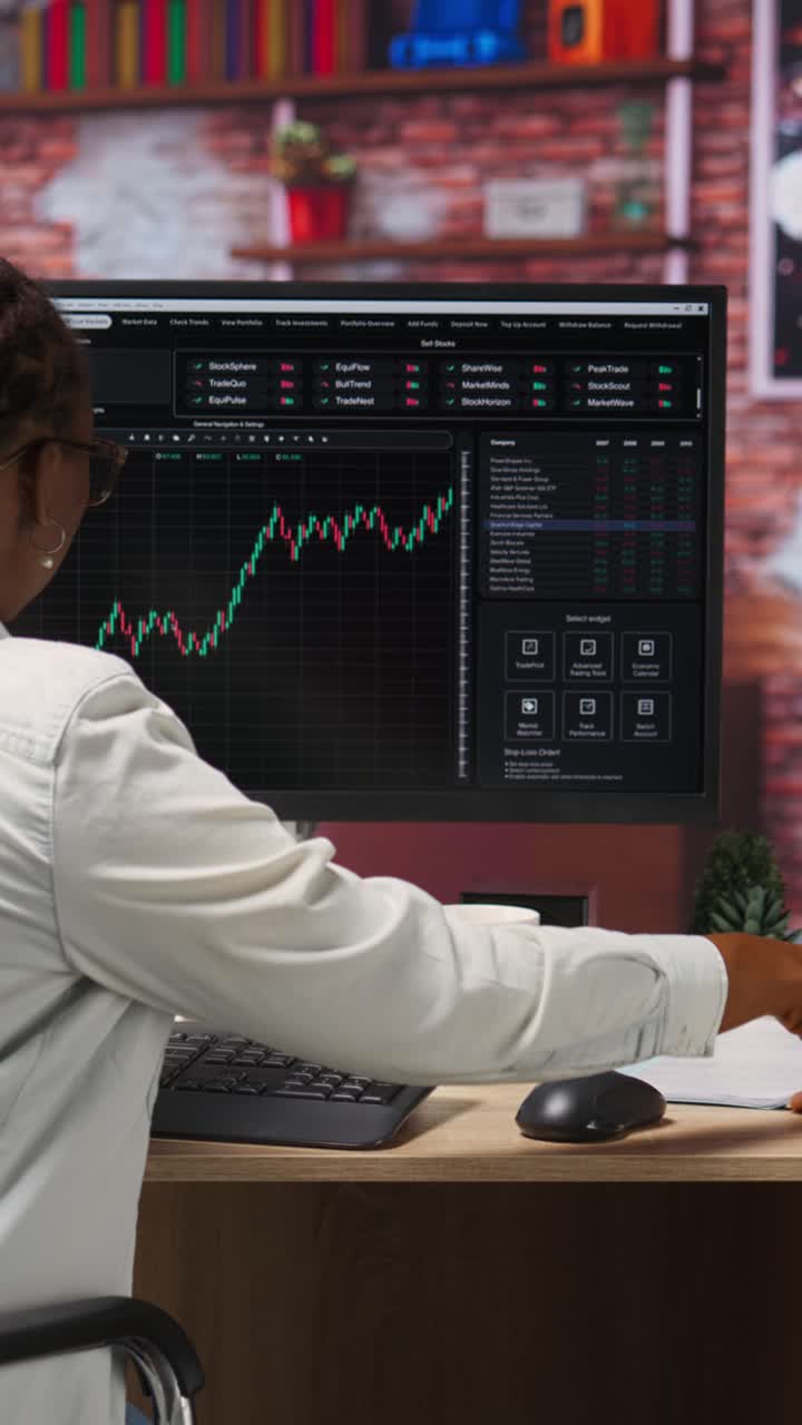 Vertical video Forex trader browsing though stock exchange portfolio pages at computer desk