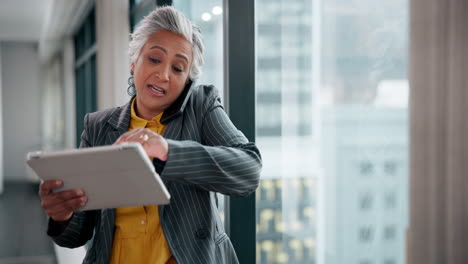 businesswoman working on tablet and taking a phone call