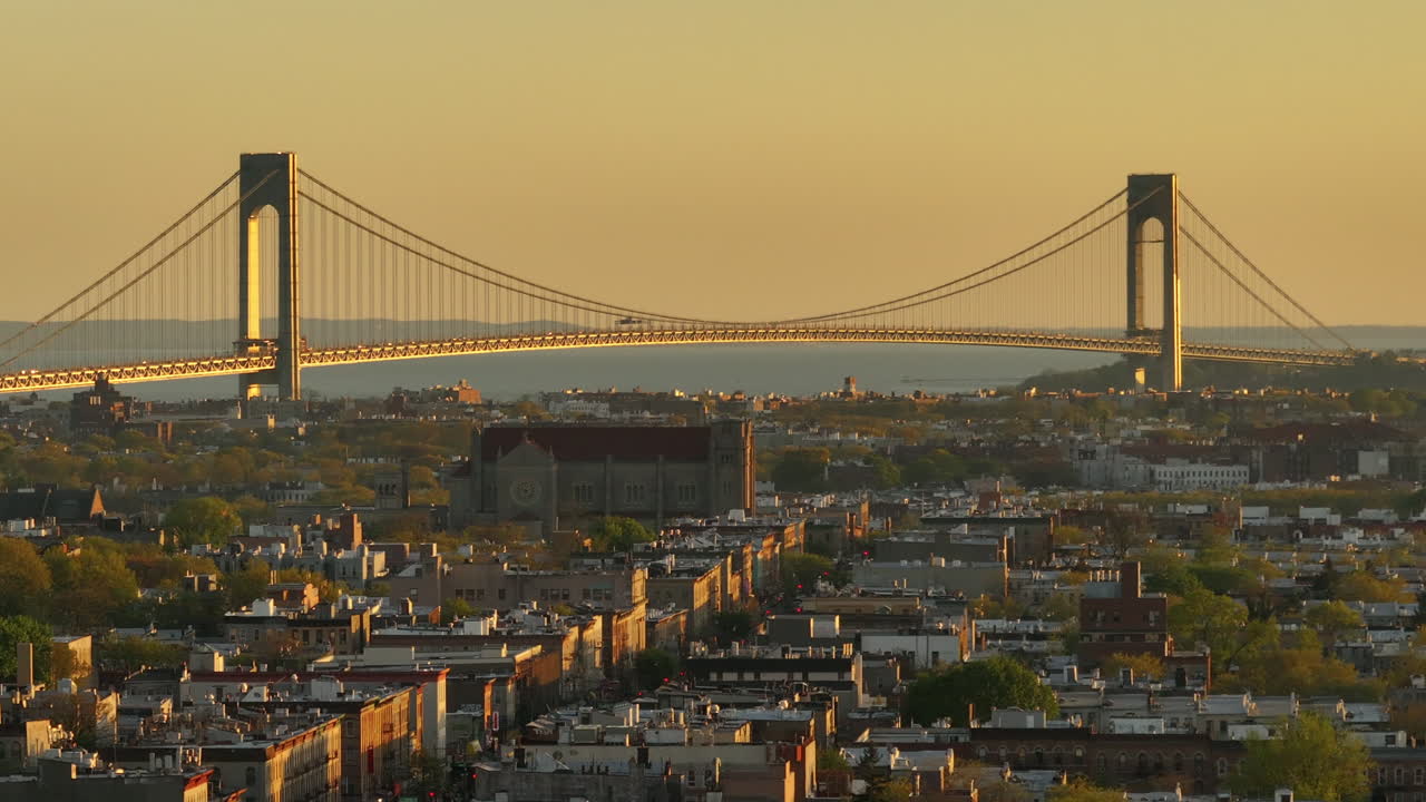 Aerial view of rush hour traffic on Brooklyn's Belt Parkway. Shot at sunset in Bay Ridge with the Verrazzano Bridge in the background.