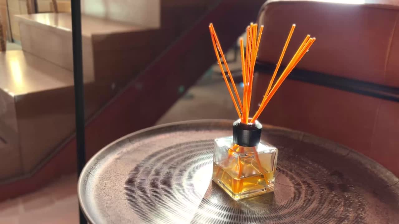 Orange fragrance sticks on a small living room table, daily home care