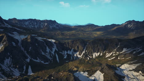 mountain range with snow capped peaks under a blue sky