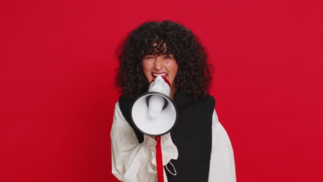 young woman talking with megaphone, proclaiming news, loudly announcing advertisement discounts sale