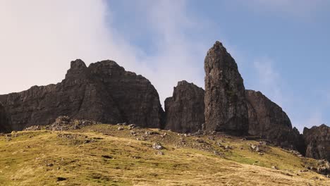 looking up at giant rock pillars of old man of storr on isle of skye, highlands of scotland