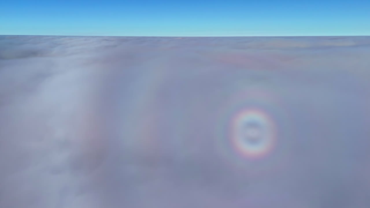 A view above the clouds in a blue sky with lens flare