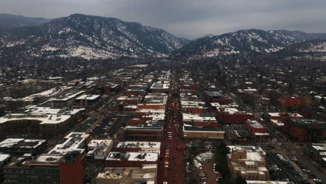 christmas in boulder colorado pearl street mall aerial drone cinematic december university of colorado cu buffs winter cloudy snowy flat irons chautauqua park cars buildings streets down motion