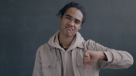 young person giving thumbs down