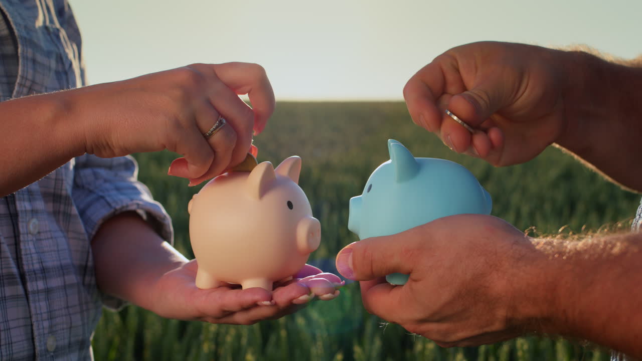 A man and a woman each put coins in their piggy bank. Separate budget and finance