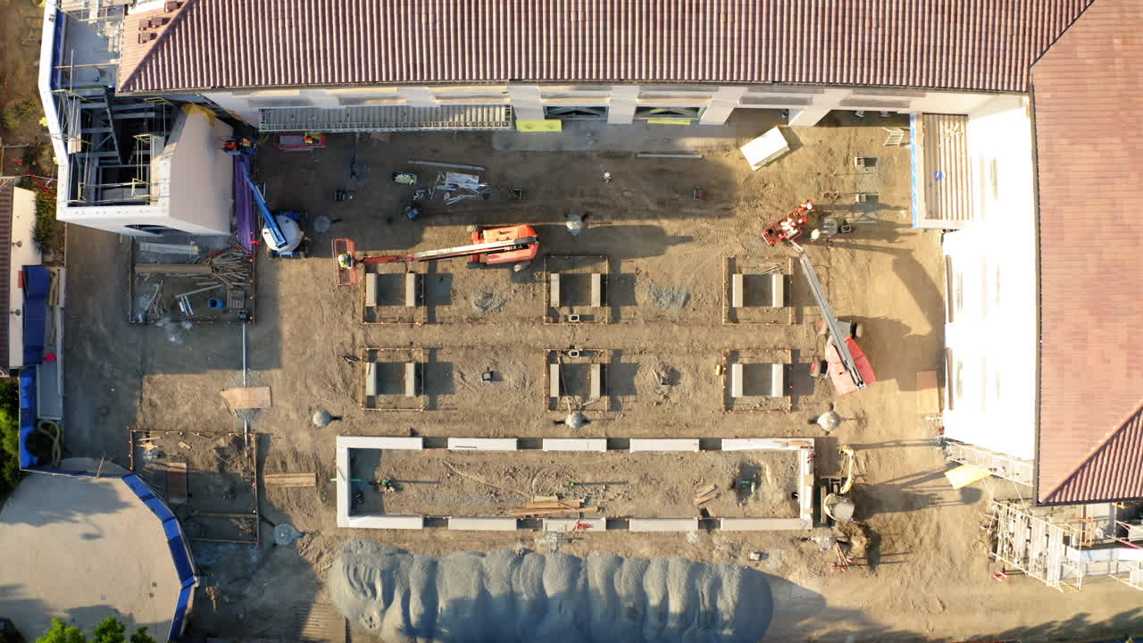 Aerial View of a Construction Site with Foundations and Equipment