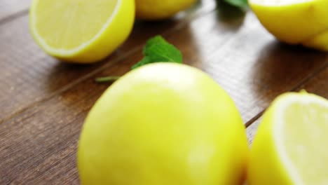 Full-and-half-lemons-with-mint-leaf-on-table