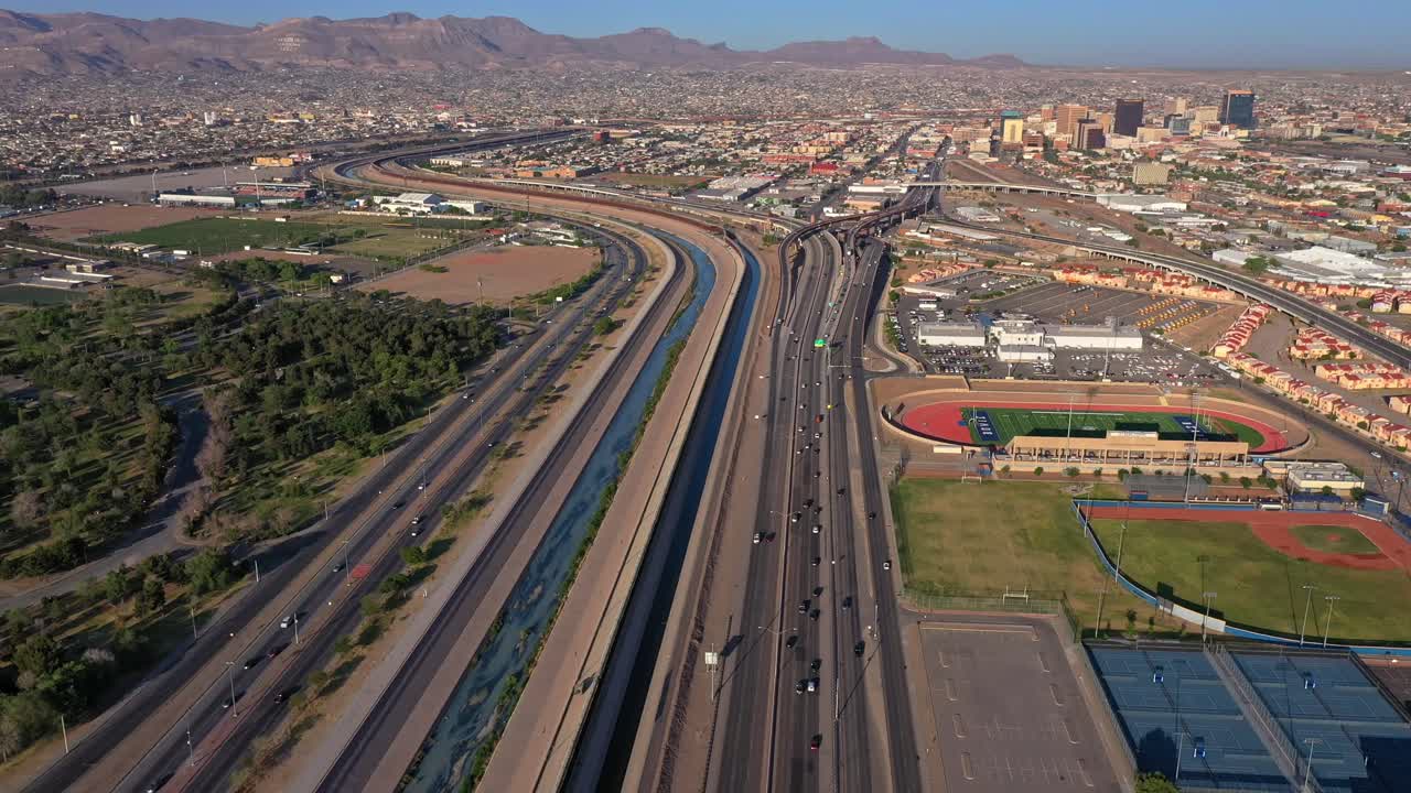 Flying over Cesar E. Chavez Border Highway (375) and Border wall in El Paso, TX before Title 42 Ends. 4k Drone Footage. Next to Av. Rafael Pérez Serna Highway in Ciudad Juárez, Mexico. Cars Driving.