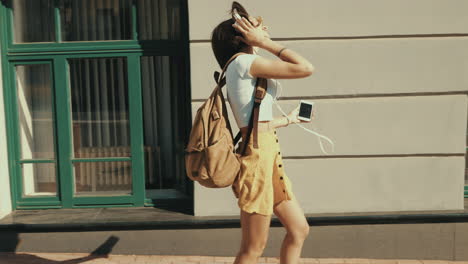 young woman walking and enjoying music