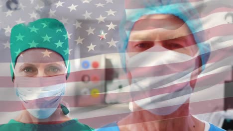 Animation-of-waving-usa-flag-over-portrait-of-caucasian-male-and-female-surgeons-at-hospital