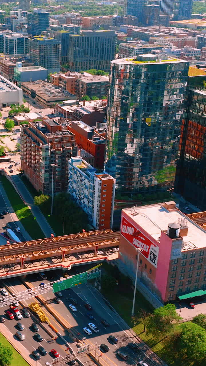 Chicago, Illinois, USA - June 01, 2024: Aerial view of train and car intersection in Chicago downtown. Vertical video