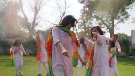 group of indian people dancing at a holi party