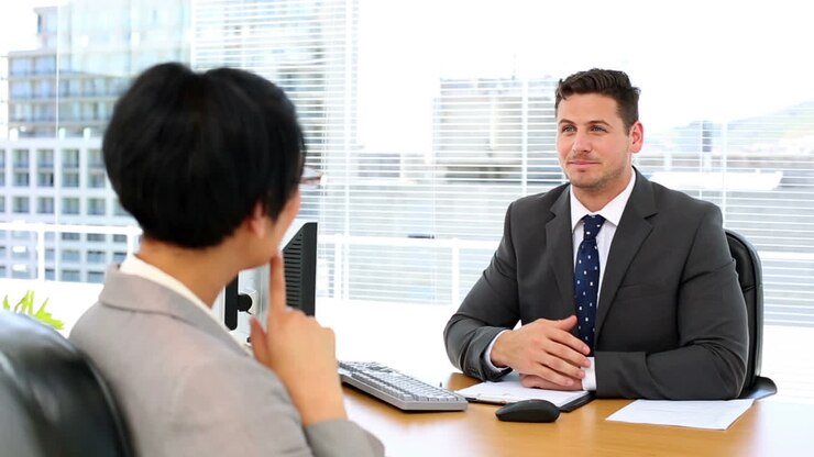 Handsome businessman talking with interviewee