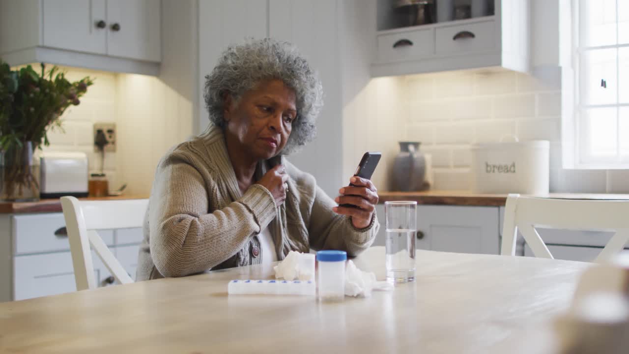 Senior african american woman having a videocall on smartphone at home