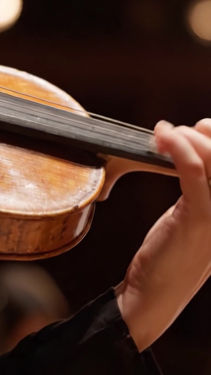 A Close-Up View of a Skilled Musician's Hand Holding a Violin, Demonstrating Precision and Craftsmanship in Classical Music Performance