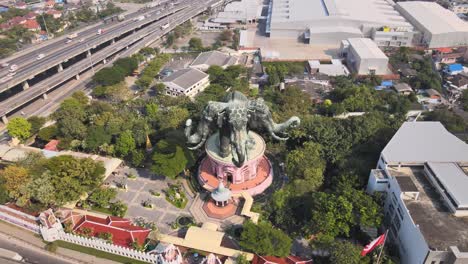 4k aerial descending shot erawan museum and a road junction in samut prakan province, bangkok, thailand