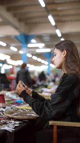 woman browsing jewelry at a flea market