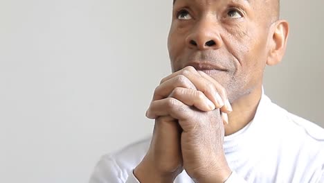 man-praying-to-god-with-hands-together-Caribbean-man-praying-with-grey-background-stock-video