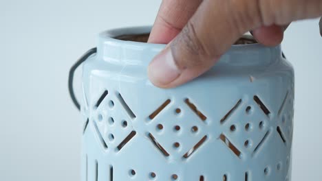 close-up of a blue ceramic candle holder with a patterned design