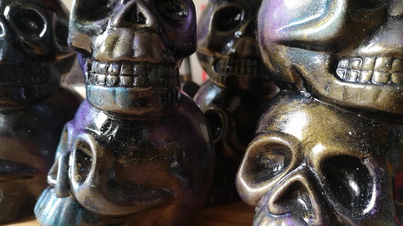 Colourful painted ceramic spooky death skull totem crafts pottery ornament left rotation closeup
