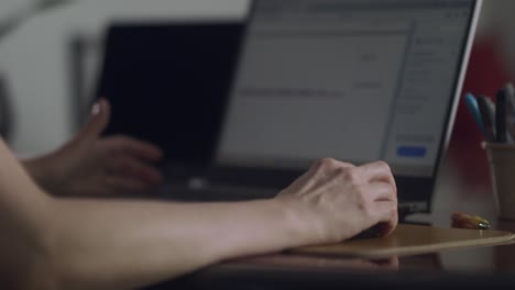 Static-shot-of-unrecognizable-woman-working-on-her-laptop,-doing-spreadsheets