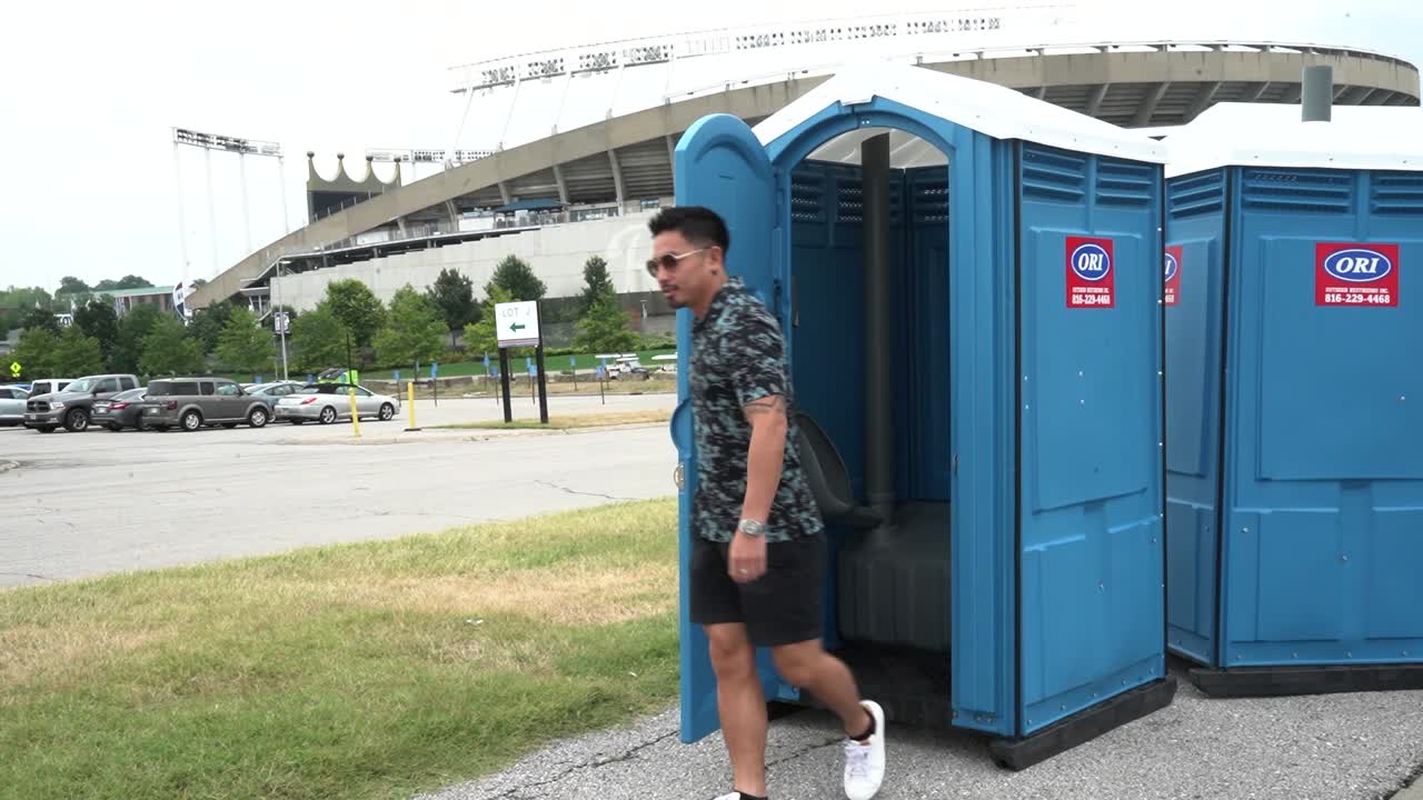 Man walks out of a porta-potty