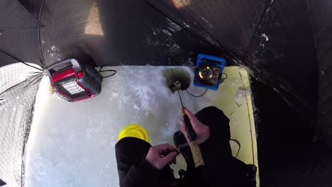 Ice-fisherman-fishing-in-tent