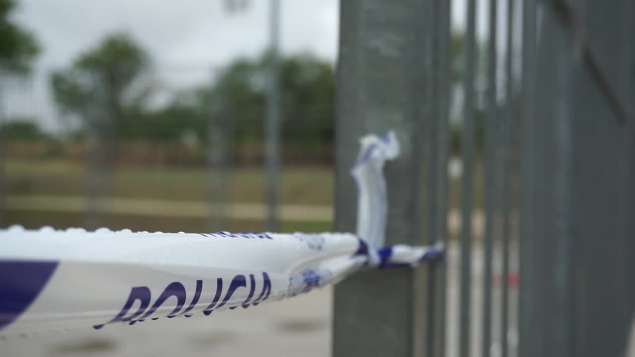Police Tape at an Outdoor Basketball Court