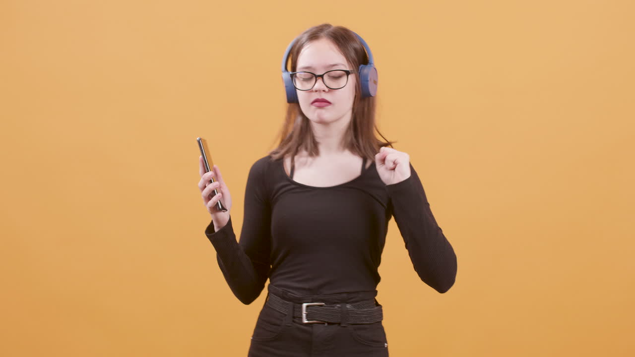 Young woman with headphones using smartphone