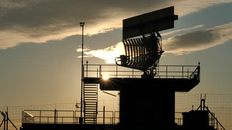 silhouetted view of an all-around antenna for air defense and tracking made of phased array technology on a rotating platform