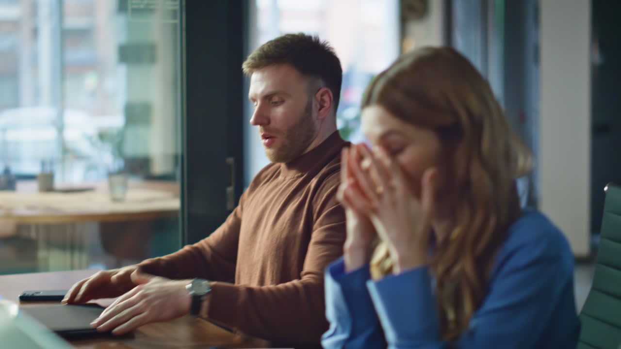 Tired managers closing laptops after busy workday in office closeup. Finish work