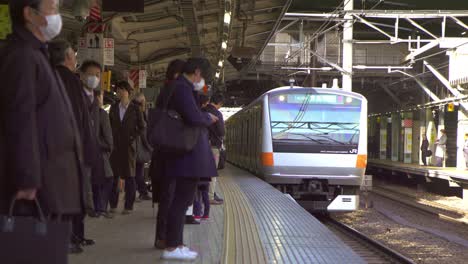 commuters waiting on platform for train