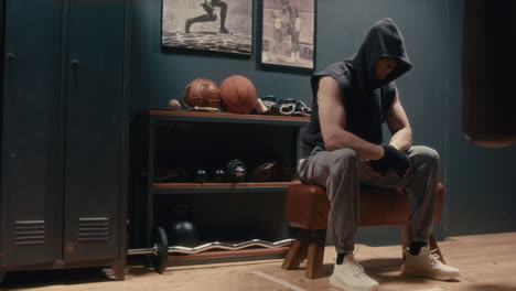 man sitting in boxing gym
