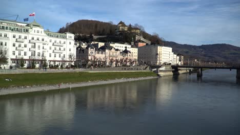 Scenic-view-of-buildings-on-the-shores-of-Salzach-river-in-Salzburg,-Austria