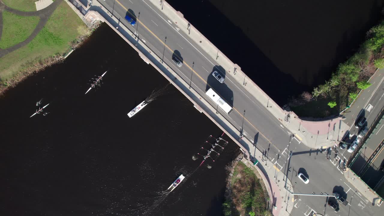 Harvard rowing teams on the Charles River, overhead 4K aerial.