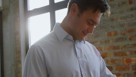 male executive using smartwatch in office 4k