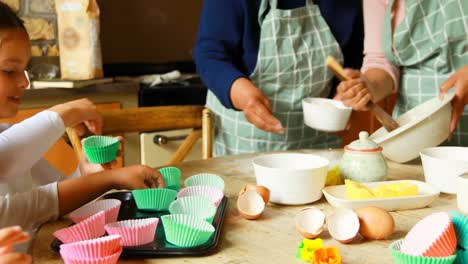 Siblings-preparing-food-with-family-in-kitchen-4k