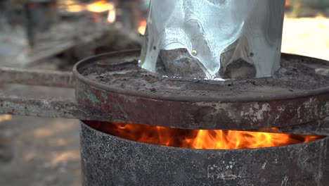 active burn barrel burning wood close-up on a farm in chiang mai thailand