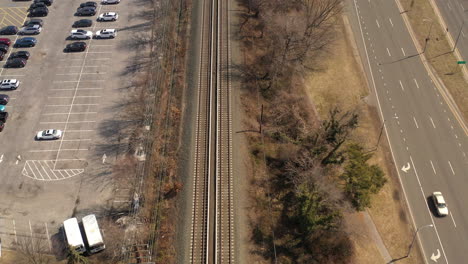 a top down shot of empty train tracks on a sunny day