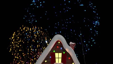 Digital-animation-of-fireworks-exploding-over-house-covered-with-snow-on-winter-landscape