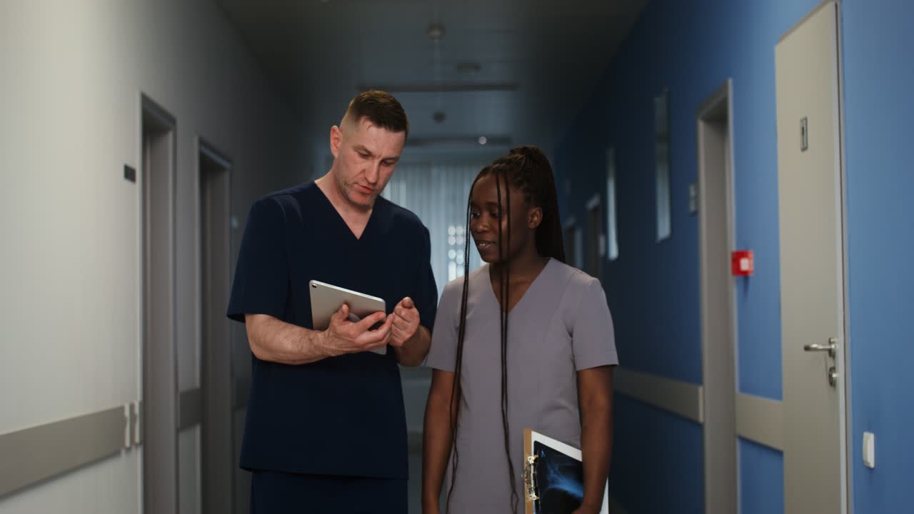Doctors discussing patient care in a hospital hallway