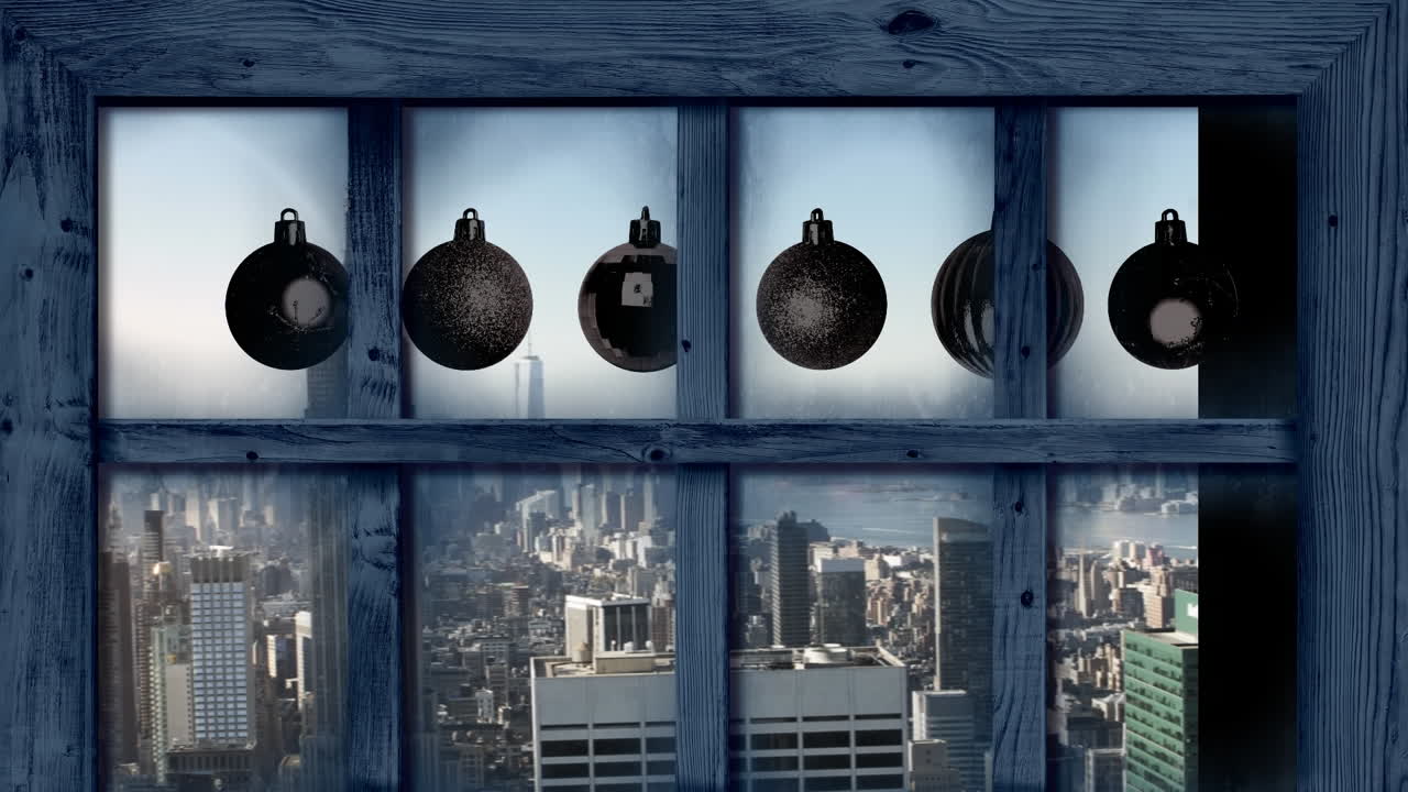 marco de ventana de madera sobre bolas de navidad y vista aérea del paisaje urbano